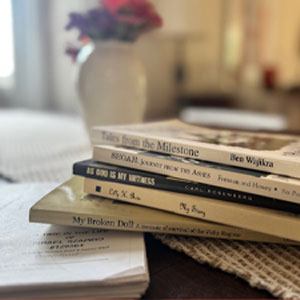 Stack of books connected to Nebraska's Holocaust survivors and camp liberators