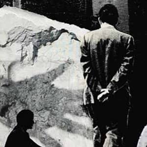 Collage by Shiri Phillips with black and white photos, handwritten papers, a shower doorway, Hebrew text,  and line drawings of a Jewish family